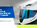 Casco bianco con visiera blu riflettente, con testo "Il nuovo standard di sicurezza ECE 22-06 per i caschi". Scopri come capire se un casco è omologato.