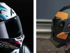 Due caschi da moto, uno bianco con grafiche colorate e il logo Shark, l'altro nero con mimetica arancione e verde. Essenziali protezioni obbligatorie moto.