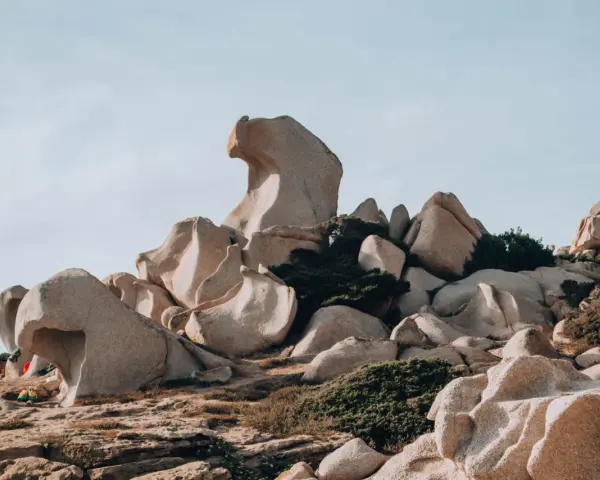 Formazioni rocciose scolpite dal vento nella Valle della Luna, Santa Teresa di Gallura. Un paesaggio lunare con rocce levigate e macchia mediterranea.